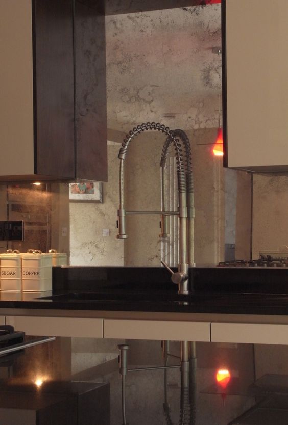 Copper faded mirror backsplash is a perfect fit for a warm colored brown kitchen, it adds chic