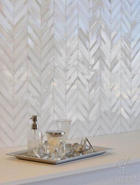 mother of pearl tiles clad in a chevron pattern for a refined bathroom