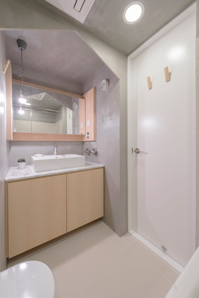 The bathroom is done in concrete and plywood, it's small and functional