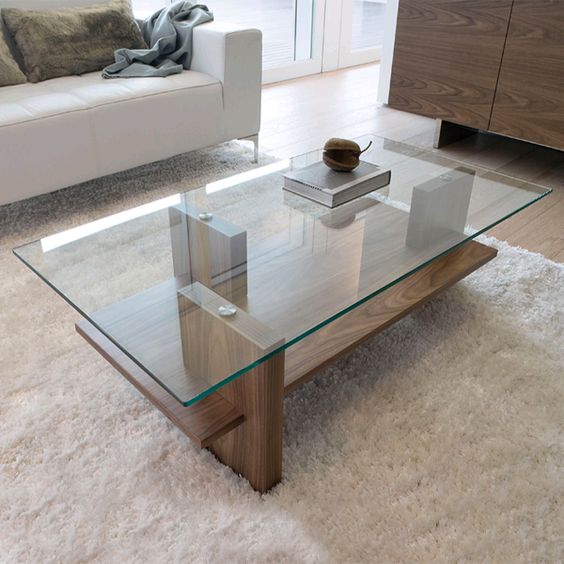 a modern zen coffee table with a wooden base and a glass tabletop, vertical stilts add eye-catchiness