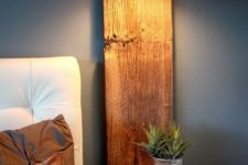 08 a rustic floating nightstand with a wooden plank attached to the wall and a horizontal part
