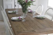 08 a whitewashed shabby chic dining room is enlivened with a large wooden trestle dining table