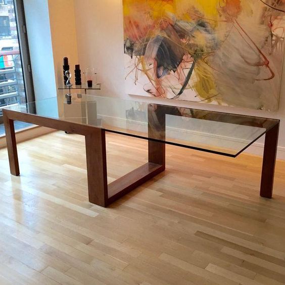modern sculptural table with a creative geo wooden frame and a large glass table top