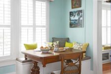 09 a dark stained wooden trestle table adds a vintage rustic feel to this small breakfast nook