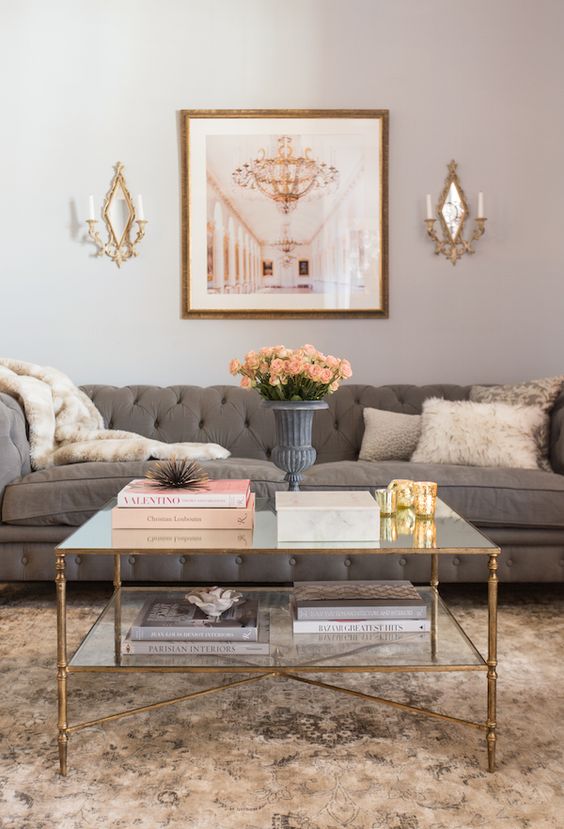 a refined copper framed coffee table with a double glass top perfectly fits a feminine space