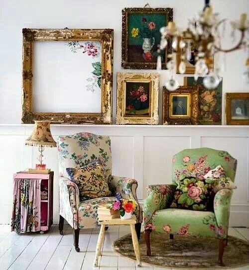 Vintage inspired space with floral upholstery chairs and vintage shabby picture frames is very refined