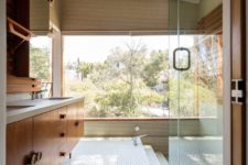 10 The bathroom is clad with hex tiles and there’s a creative bath area with a view