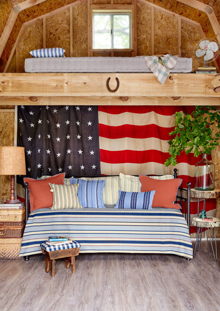 a living room and bedroom decorated in patriotic style, with cozy traditional furniture