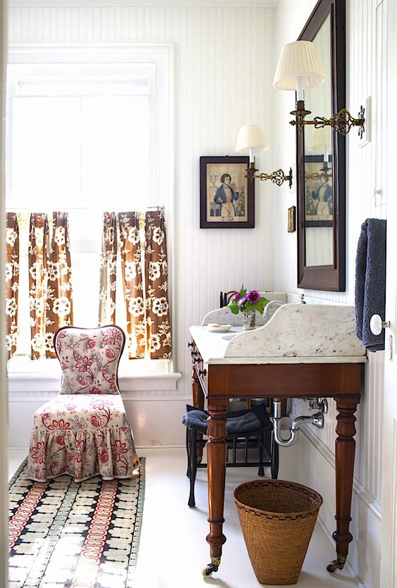 a vintage desk placed on casters and with a new top for a vintage-inspired bathroom