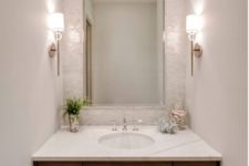 10 small mother of pearl tiles accentuate the sink zone and spruce up a neutral bathroom
