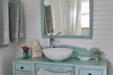 11 a mint-colored desk turned into a vanity with a curtain and a matching mirror