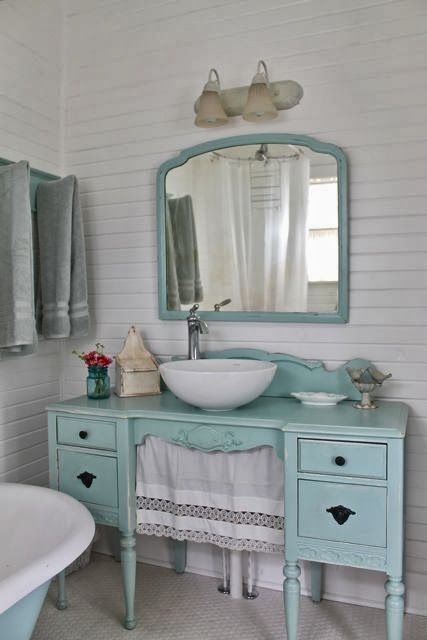 a mint-colored desk turned into a vanity with a curtain and a matching mirror