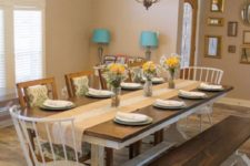 11 a rustic dining space with a wooden tabletop and white legs and a matching bench looks cozy and intimate