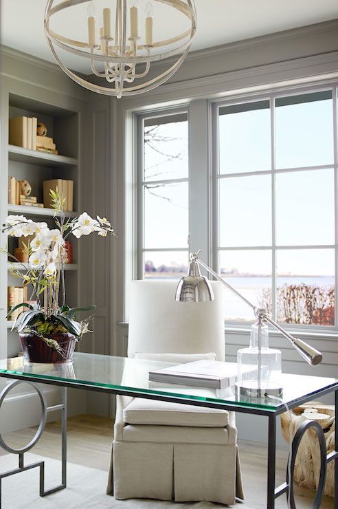 Vintage inspired home office with a durable desk on geo metal legs and a with a glass tabletop