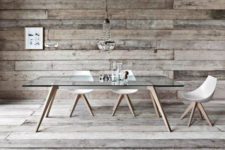 12 a dining table with wooden legs and a glass tabletop for a rustic space with a modern feel