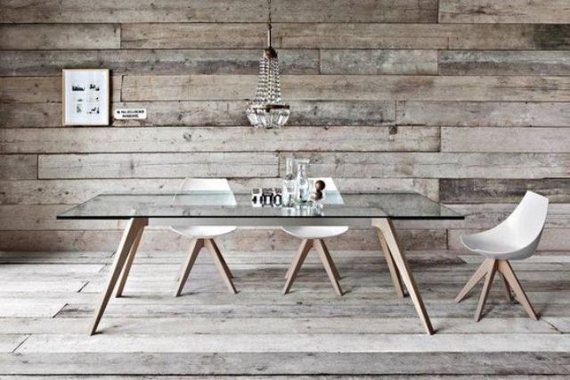 a dining table with wooden legs and a glass tabletop for a rustic space with a modern feel