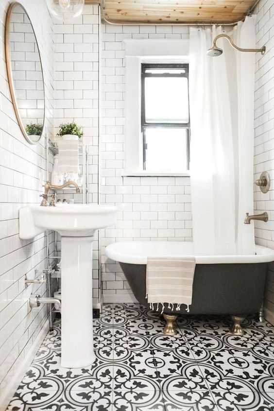 a white vintage-inspired bathroom with patterned black and white floor tiles