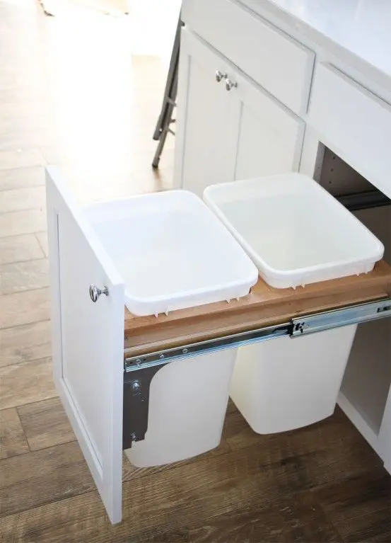 pull out trash cans hidden inside a kitchen cabinet