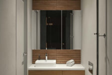 13 The second bathroom is done in light grey and with the use of natural wood