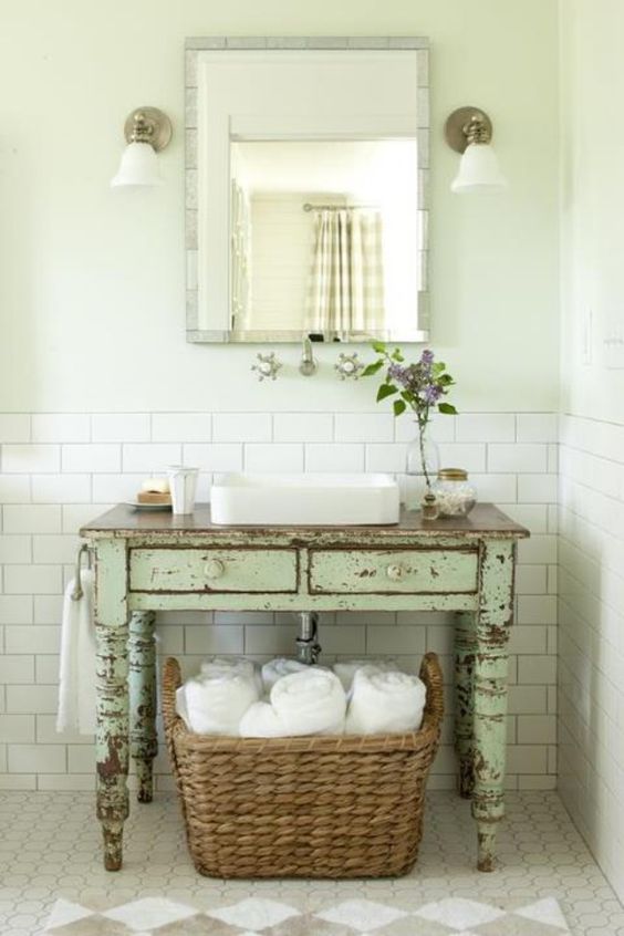 A mint colored shabby chic desk to use as a bathroom vanity to make the space more rustic and shabby