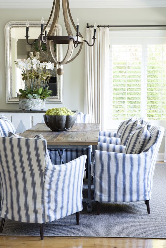 a traditional cottage dining room with blue and white striped armchairs for comfort and chic