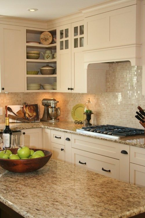 shiny mother of pearl backsplash tiles for sprucing up a creamy kitchen
