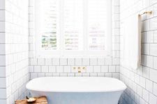 14 blue patterned tiles on the floor and white subway tiles for a gorgeous bathroom
