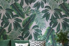 14 mixed tropical leaf wallpaper and a matching emerald sofa are ideal for a summer living room