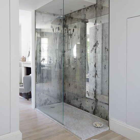 two silver faded mirror shower walls highlight this space and make it more special