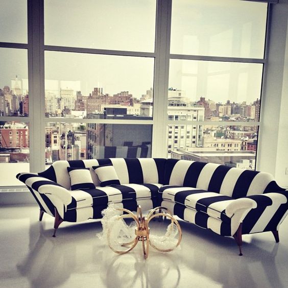 a black and white striped sofa looks quirky and cool, what can be better for a modern interior
