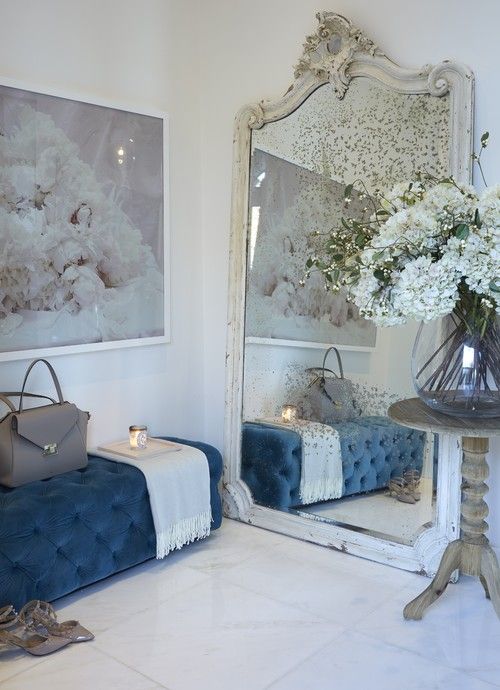 a faded mirror in a vintage white frame makes this girlish entryway refined