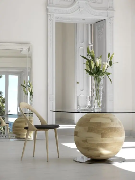 a round glass tabletop table with a unique wood ball base looks wow