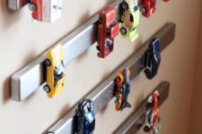 15 magnet toy car storage is a genius idea for a boy’s playroom