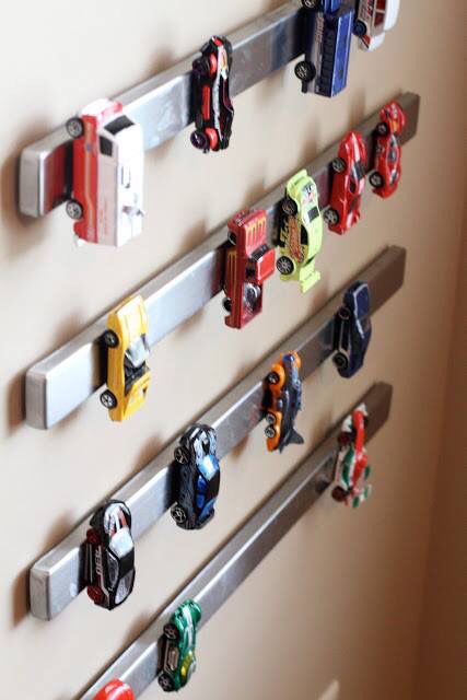 magnet toy car storage is a genius idea for a boy's playroom