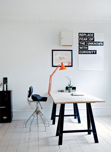 A modern laconic version of popular trestle desk   black legs and a wooden tabletop