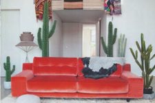 16 desert-inspired space with a fiery-red velvet sofa and cacti