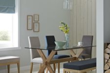 17 a trestle table with a glass tabletop and comfy upholstered chairs for a cozy and simple dining space
