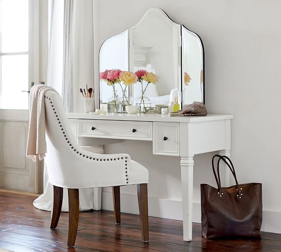 An antique desk painted white with small black knobs   just add a large mirror and you are done