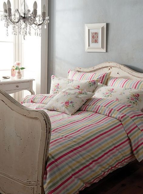 Colorful striped vintage inspired bedding with floral print pillow cases