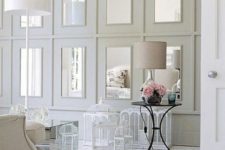 17 repeated mirrors in large white frames on the wall make the shabby chic space a bit more modern