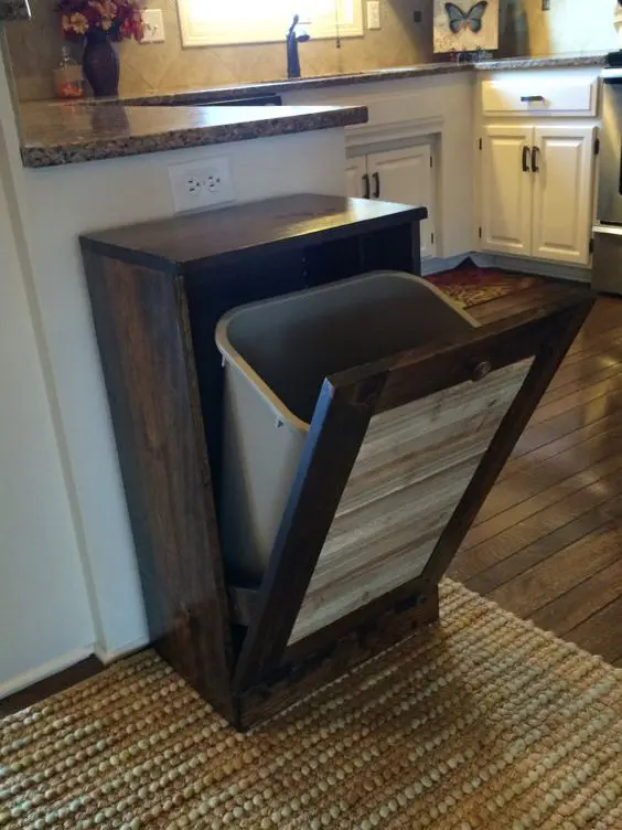 tilt out rustic cabinet with a trash can hidden inside