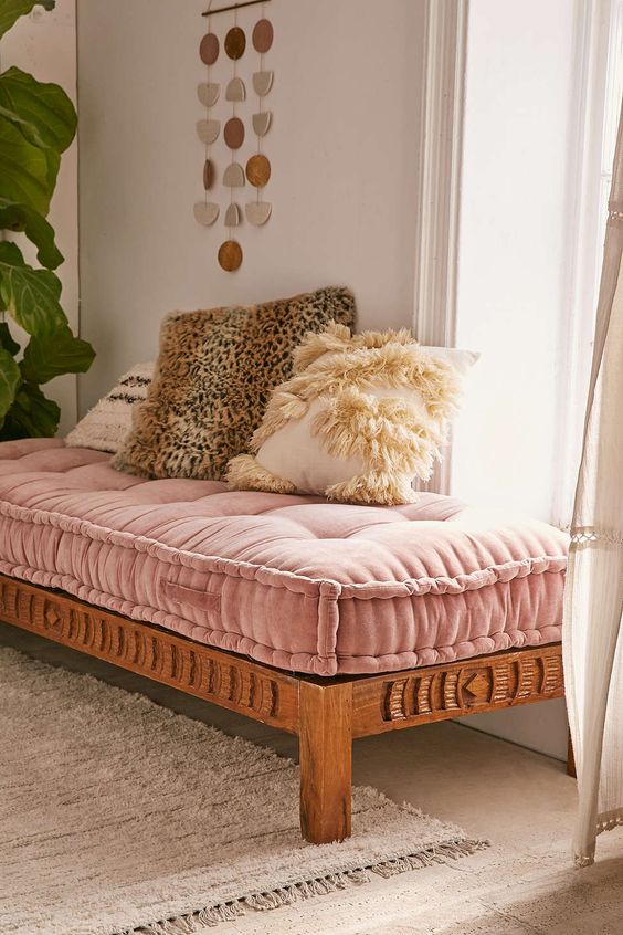A pink velvet daybed for a boho inspired girlish space and fluffy fur pillows