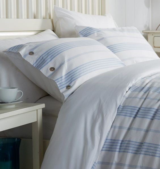 blue and white striped bedding set with buttons for a peaceful coastal bedroom