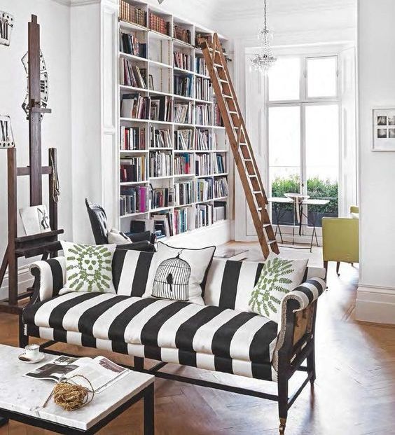 Make a white space more eye catchy with a striped black and white sofa