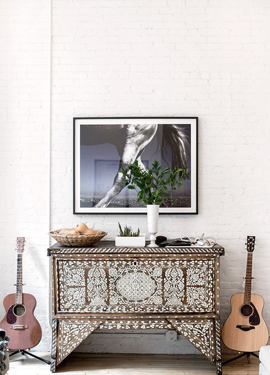 a boho chic wooden sideboard clad with mother of pearl for a creative and unique look