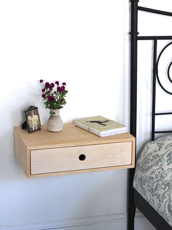 a cute wooden nightstand with a drawer is a great solution for many spaces