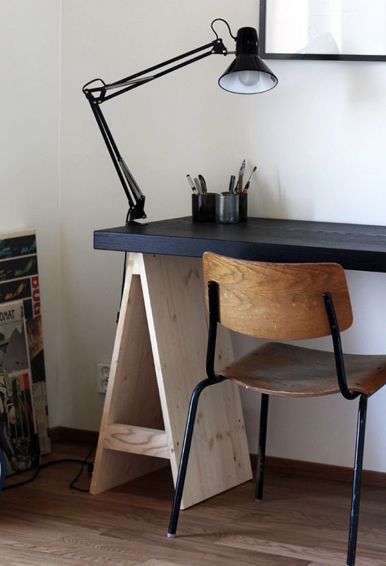 Adapt your trestle desk to the style of your space like here   the desktop was painted black to make it look more masculine