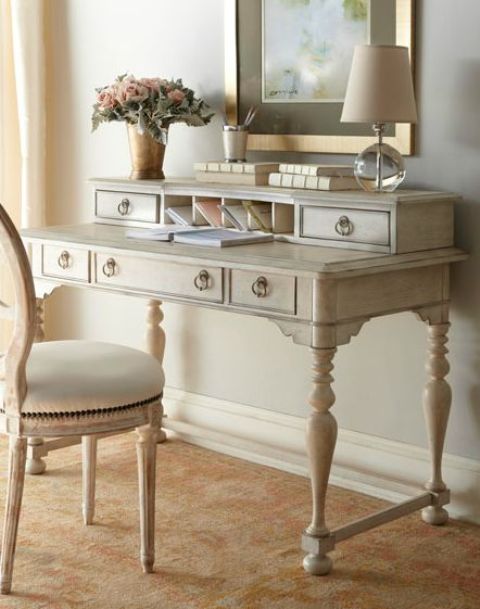 An antique bureau painted off white for a feminine home office and a matching chair