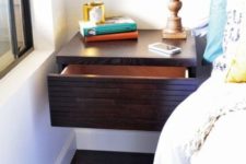 20 a dark stained floating nightstand with a large drawer