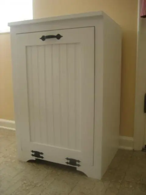 a traditional white cabinet in your kitchen can hide the trash can